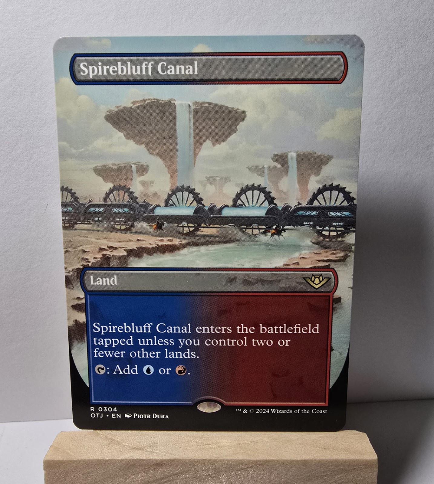 Spirebluff Canal (Borderless), Outlaws of Thunder Junction, MTG, Regular Print