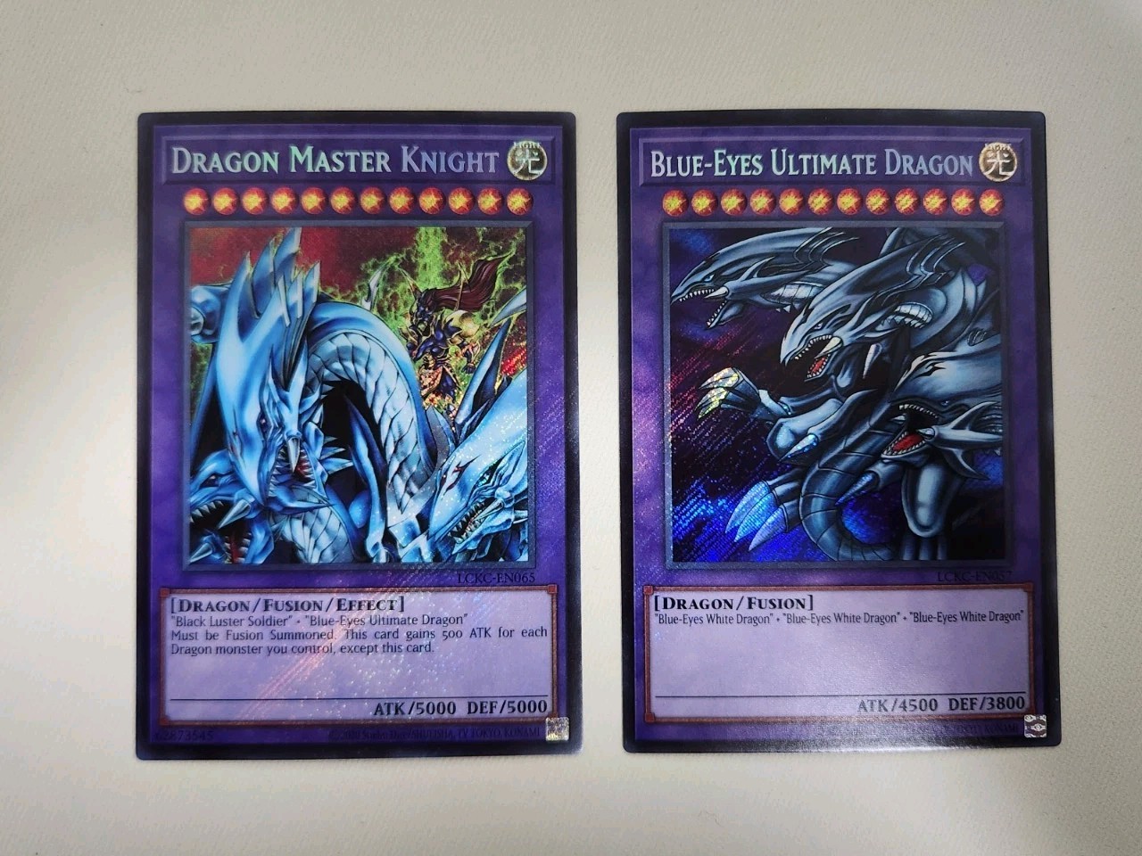 Yugioh 2x Set/ Dragon Master Knight + Ultimate Dragon/ Secret Rares LCKC NM/MINT