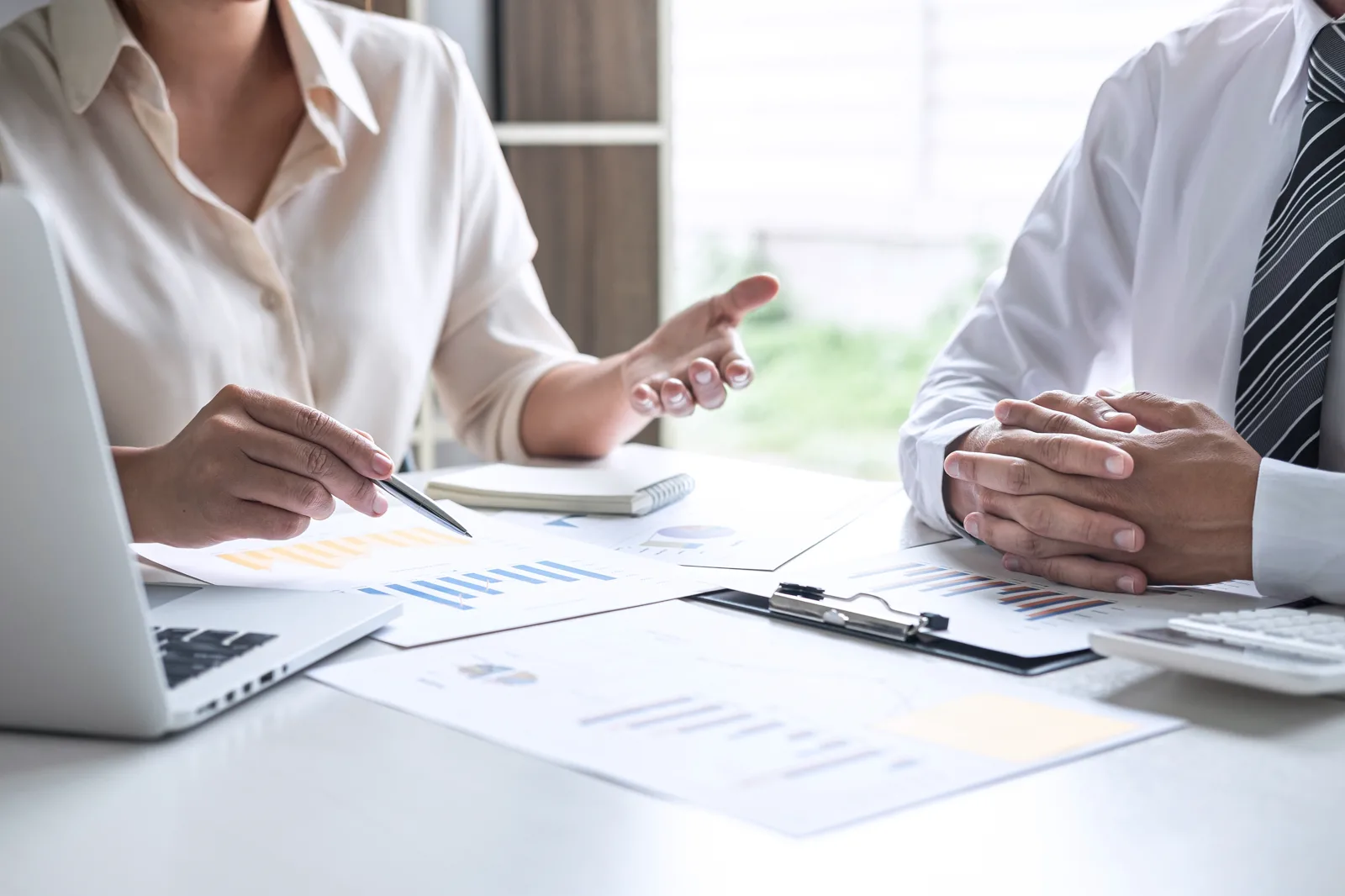 Two people reviewing eviction paperwork together at a desk during a free consultation